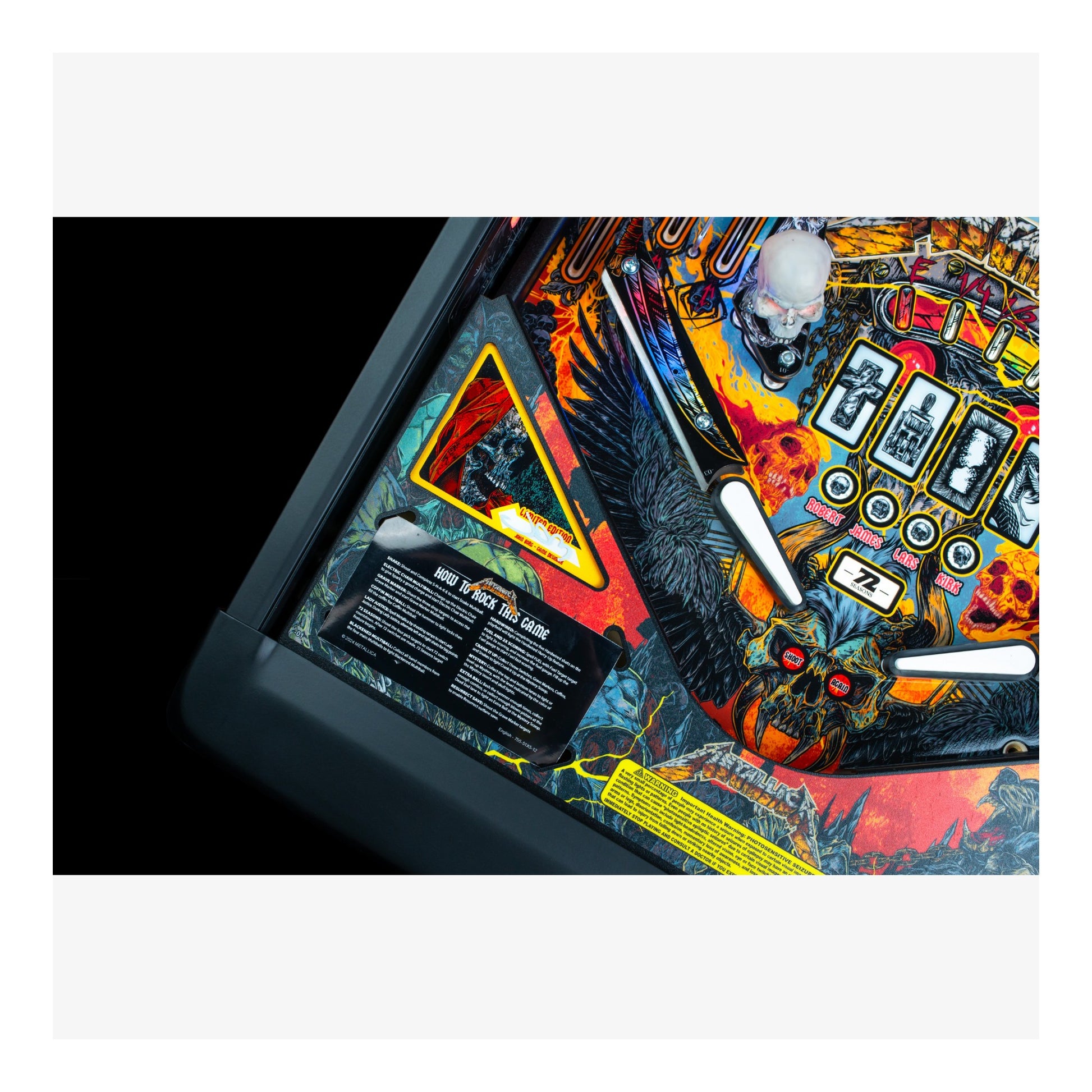 Close-up of a colorful pinball machine with intricate details on a white background