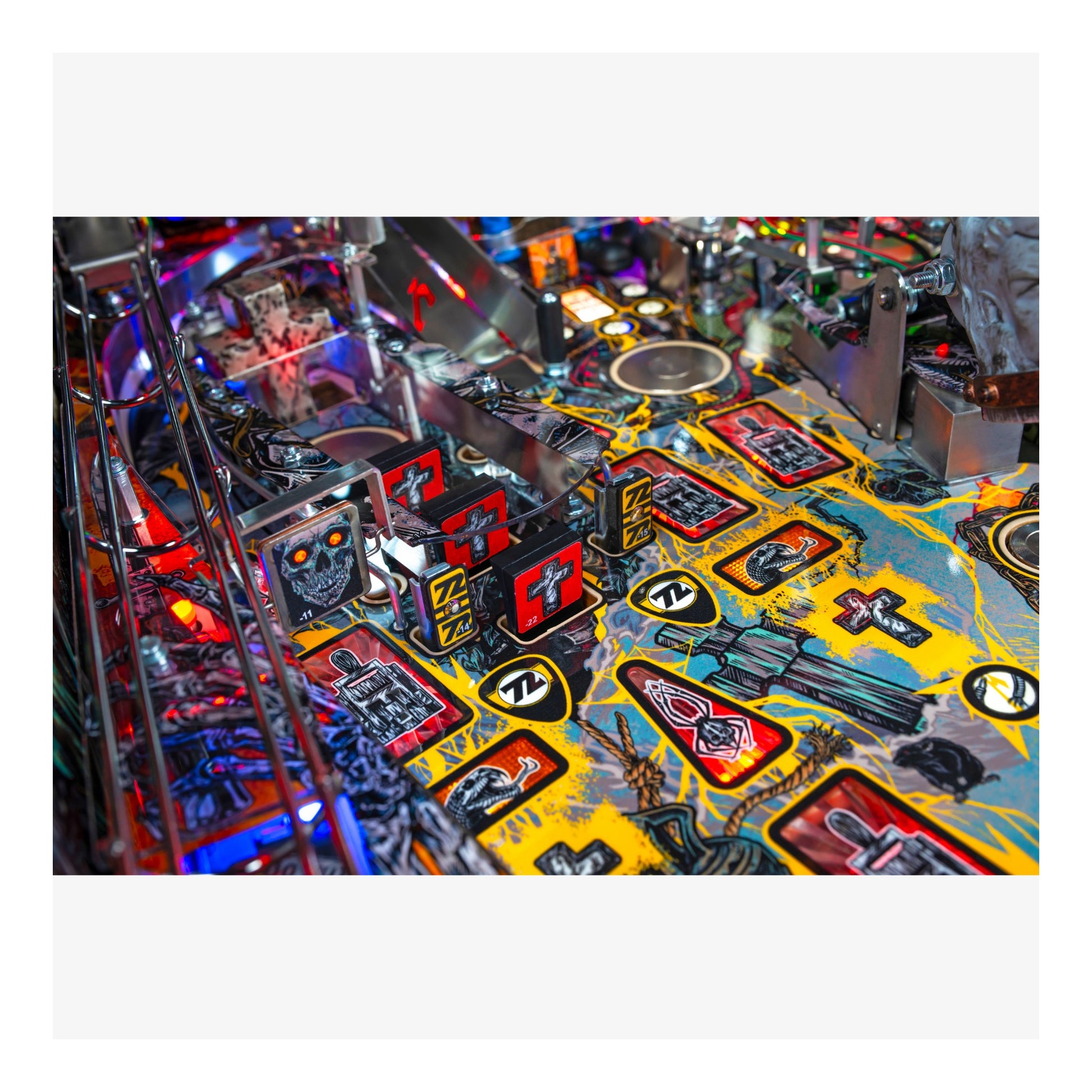 Close-up of a colorful pinball machine with various symbols and designs.