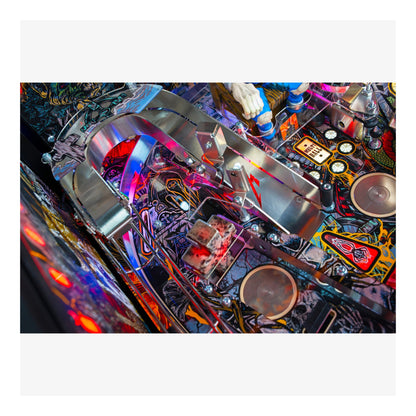 Close-up of a colorful pinball machine with various components and lights.