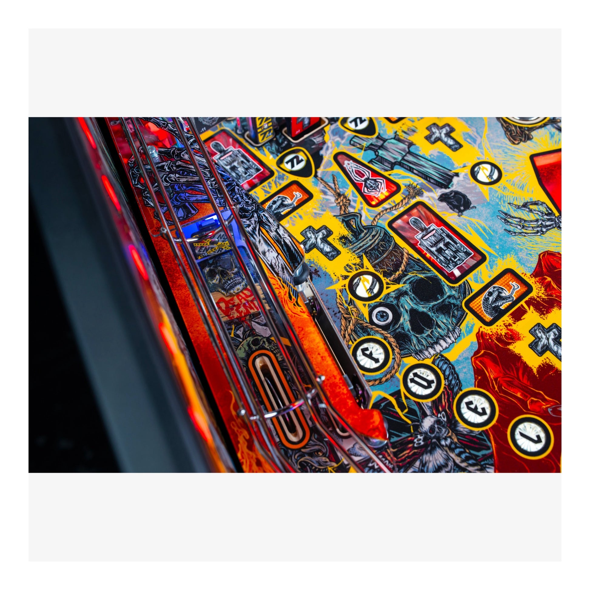 Close-up of a colorful pinball machine with various symbols and designs.