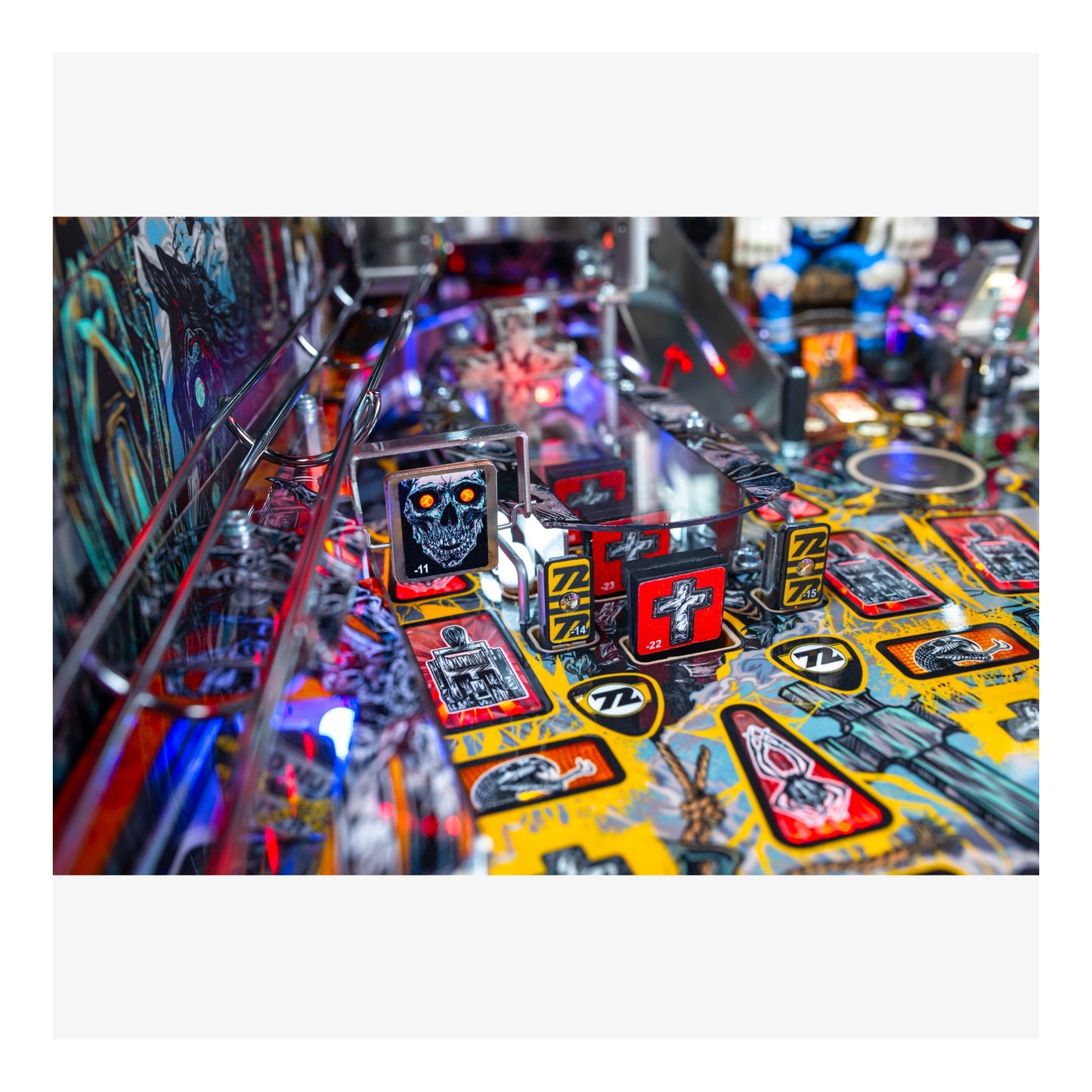 Close-up of a pinball machine with colorful playfield and various symbols.