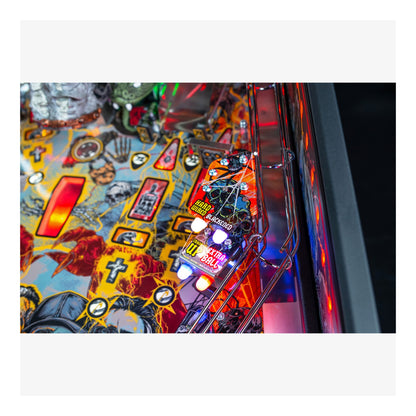 Close-up of a colorful pinball machine with vibrant graphics and lights.