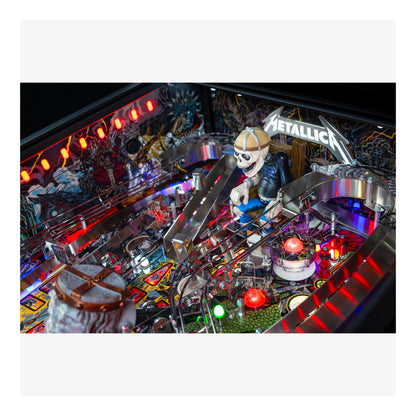 Close-up of a pinball machine with 'Metallica' branding and colorful lights.