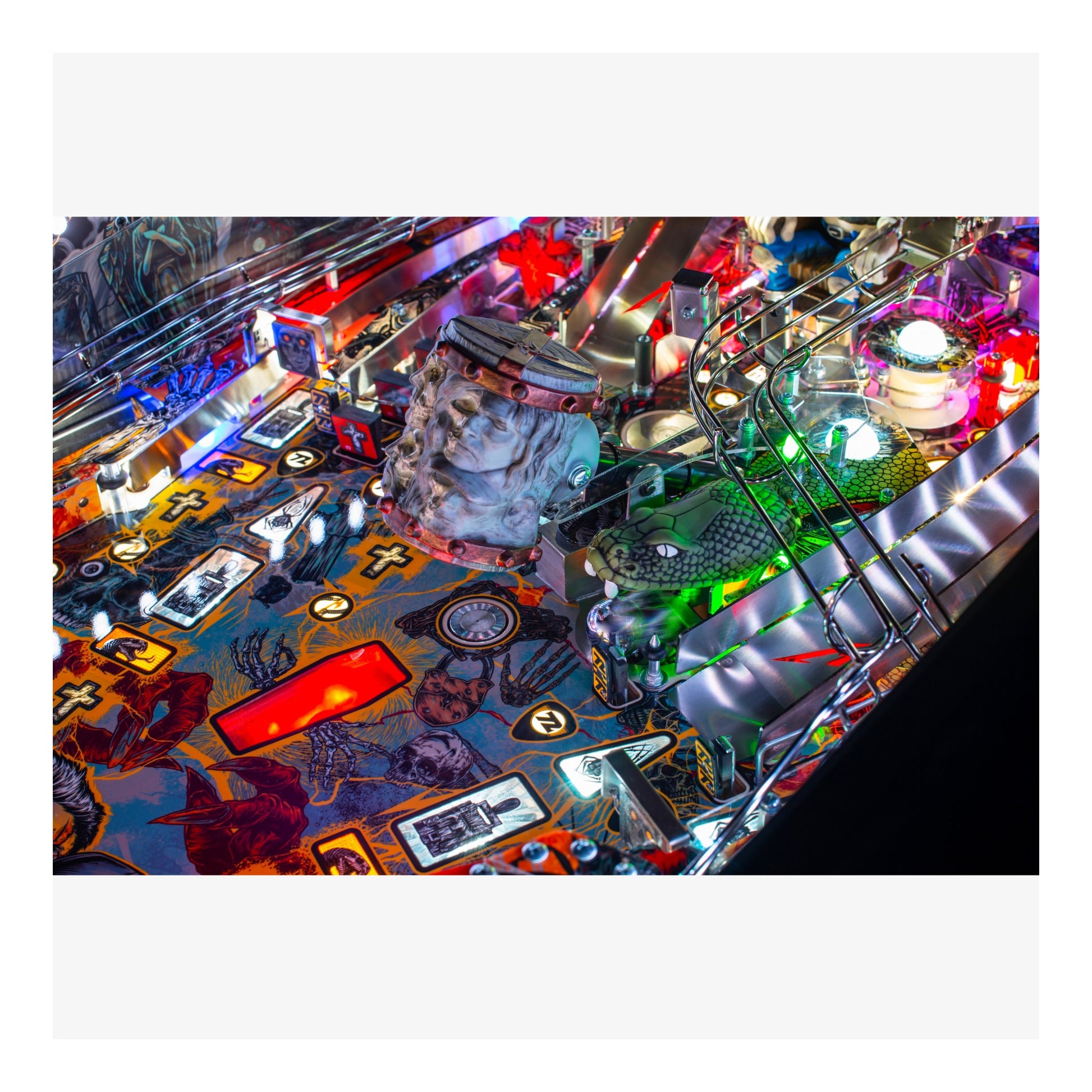 Close-up of a pinball machine with colorful lights and details