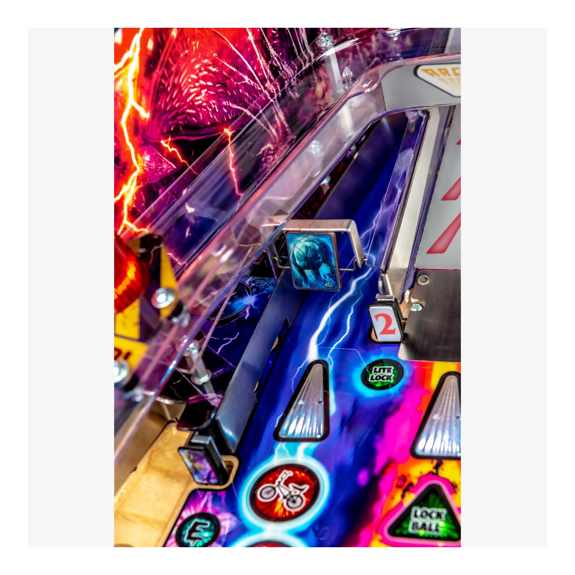 Close-up of a colorful pinball machine with vibrant neon lights.