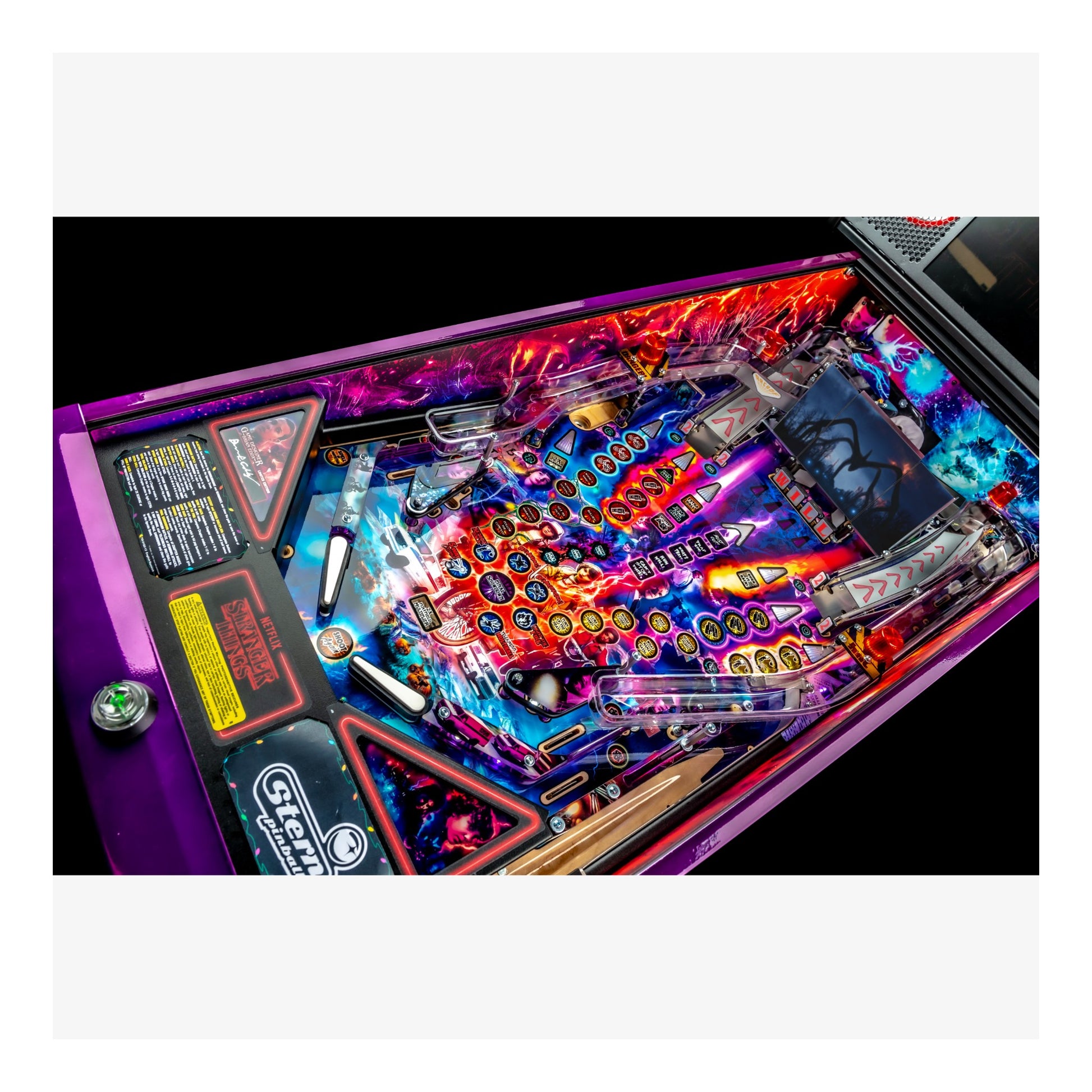 Close-up of a colorful pinball machine with vibrant lights and details.