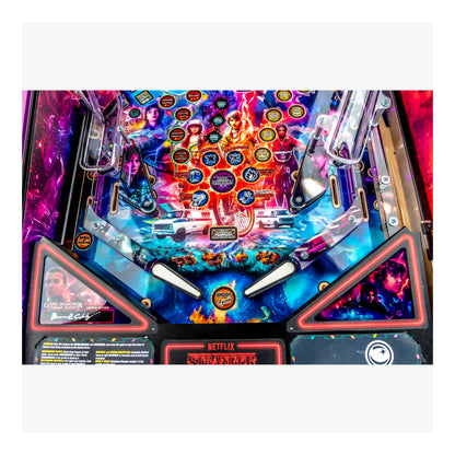 Pinball machine with colorful design featuring characters and branding on a white background