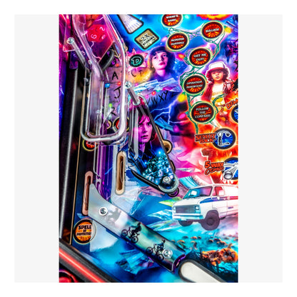 Colorful pinball machine with vibrant graphics and characters on a white background