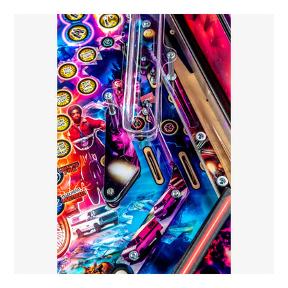 Close-up of a colorful pinball machine with vibrant graphics and bright colors.