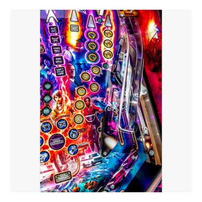 Close-up of a colorful pinball machine with various buttons and lights.