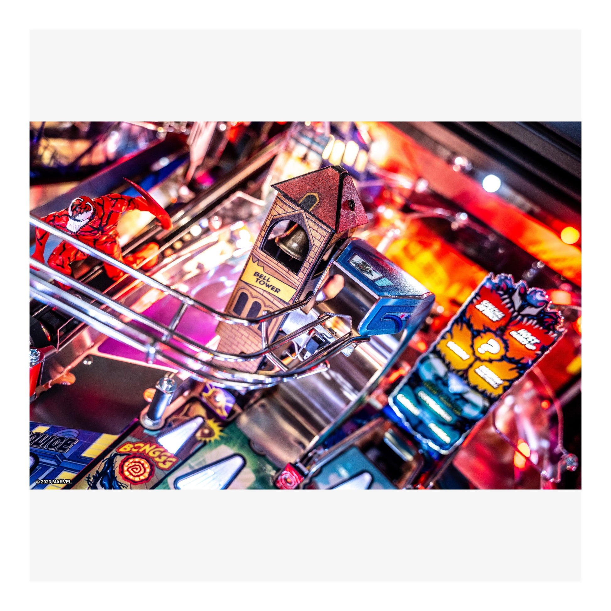 Close-up of a pinball machine with colorful lights and details