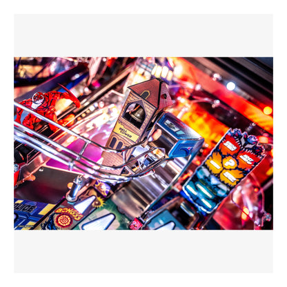 Close-up of a pinball machine with colorful lights and details