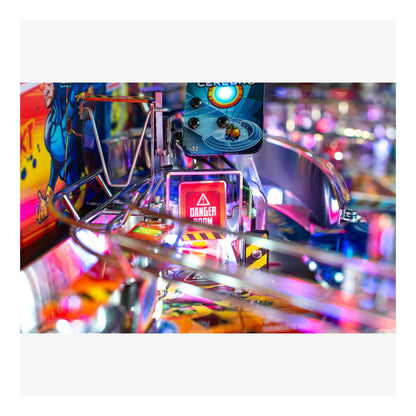 Close-up of a colorful pinball machine with vibrant lights and details.