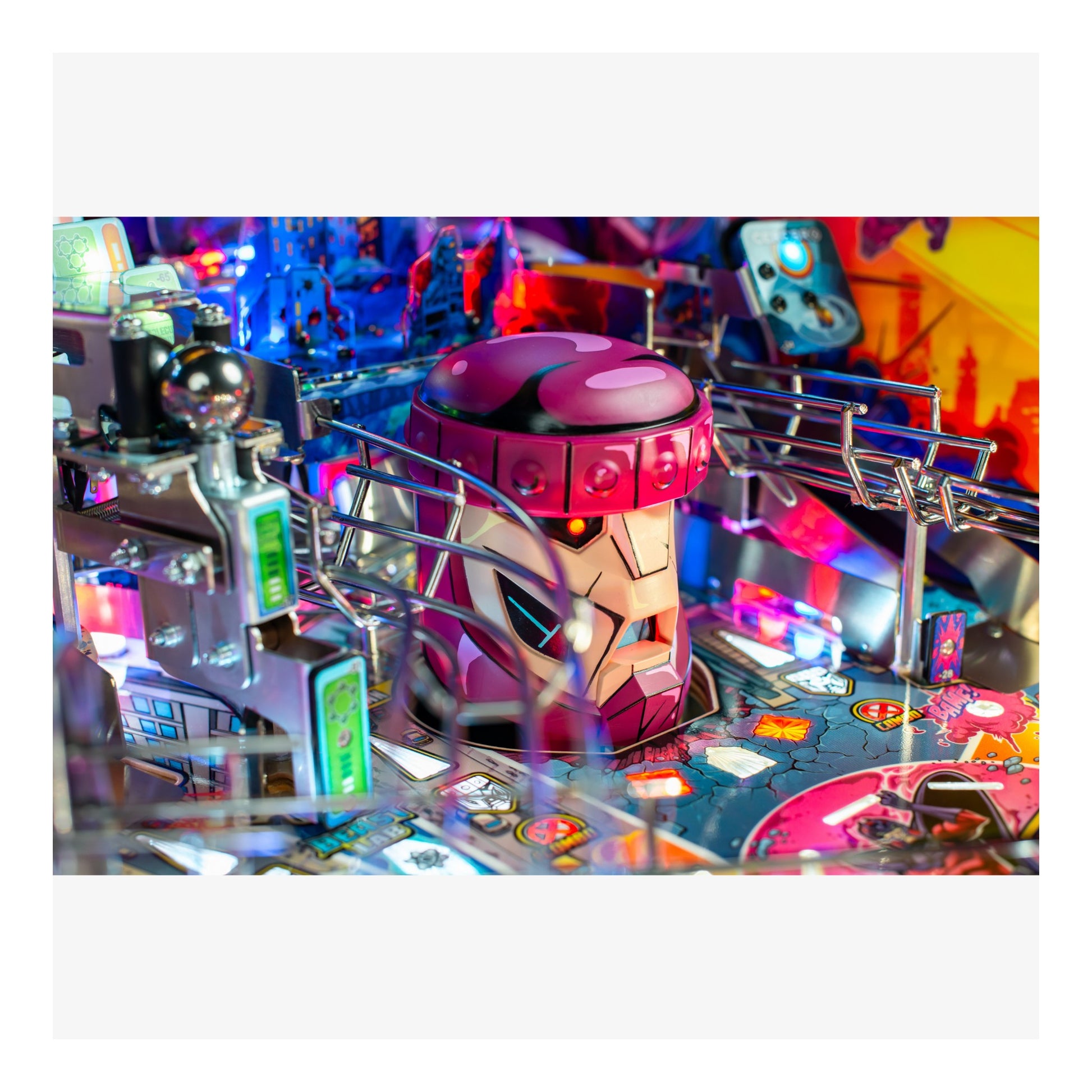 Close-up of a pinball machine with a robot figure on a colorful background