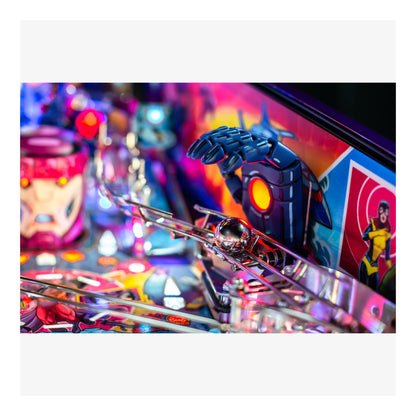 Close-up of a pinball machine with colorful design and robot figure.