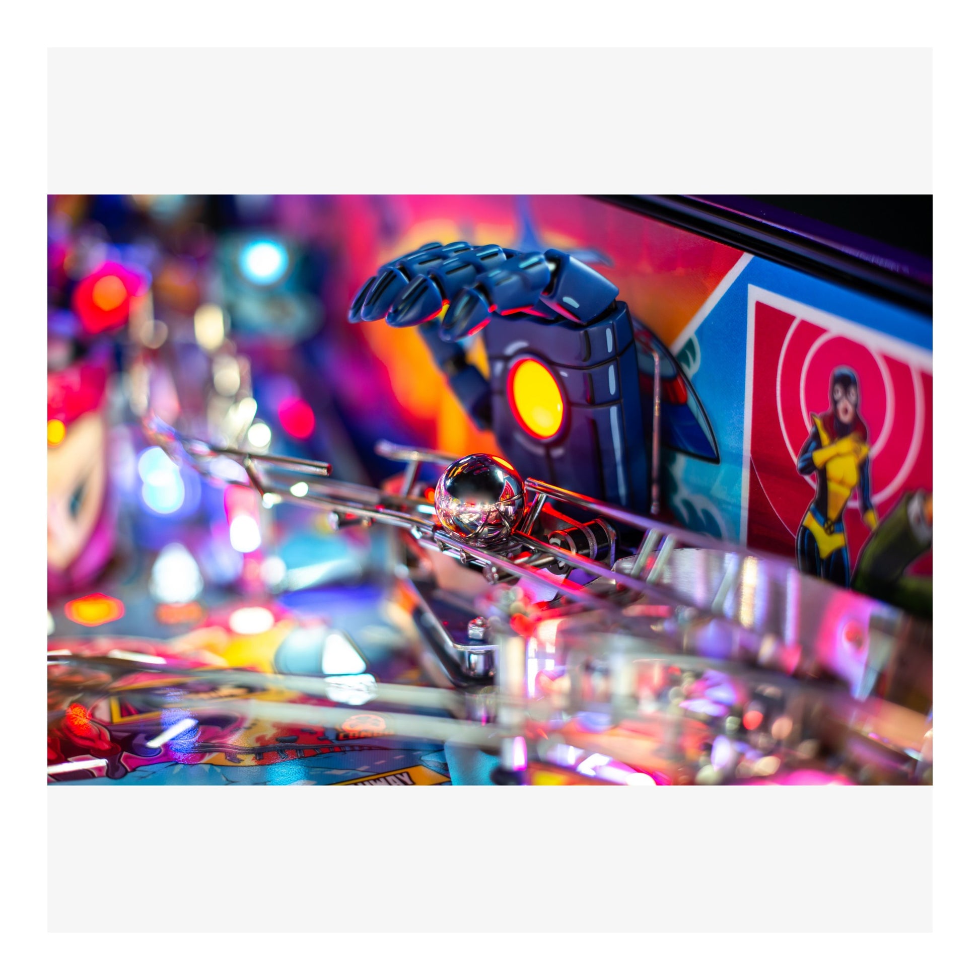 Close-up of a pinball machine with colorful playfield and vibrant lights.