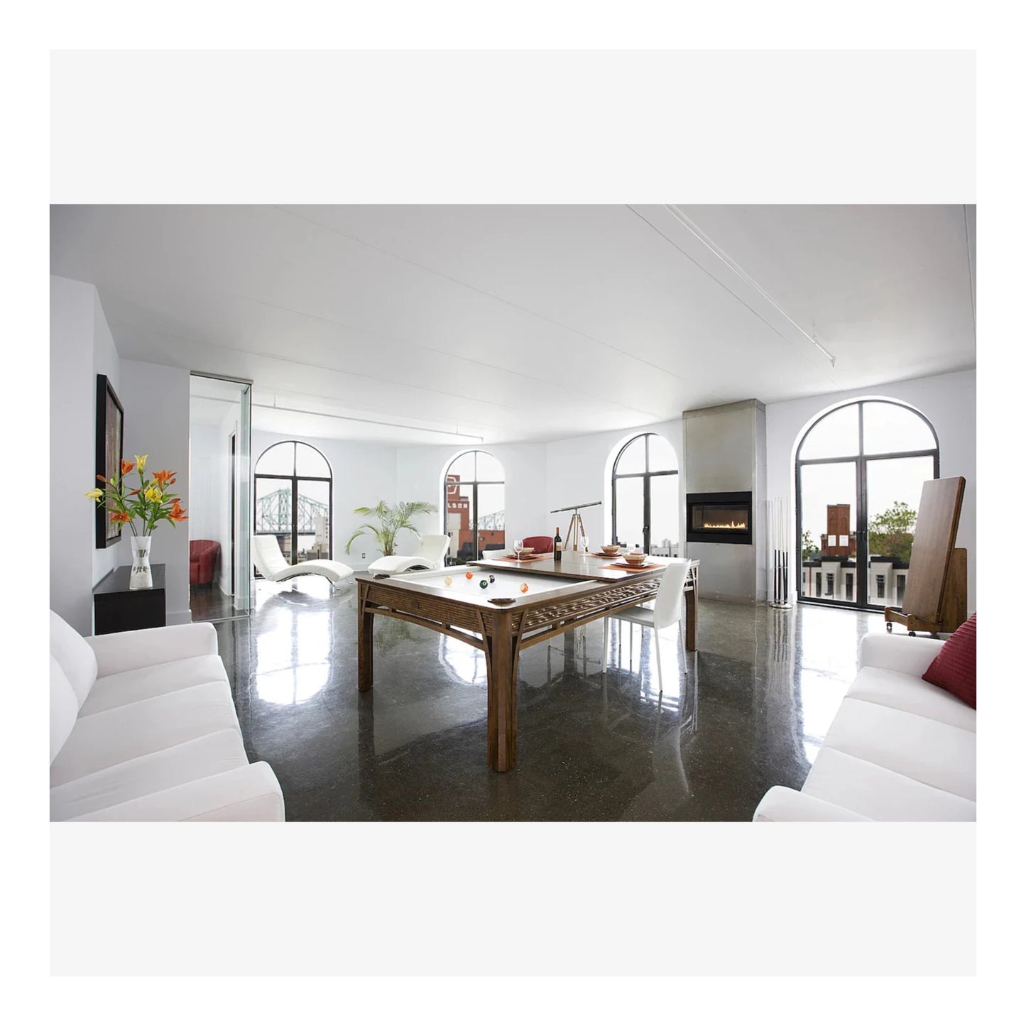 Modern living room with a pool table and white furniture
