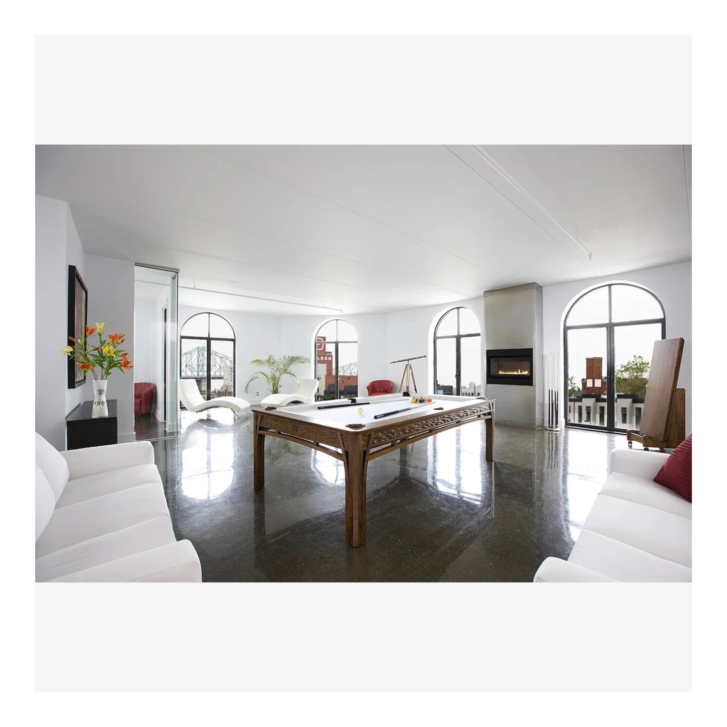 Modern living room with a pool table and white decor