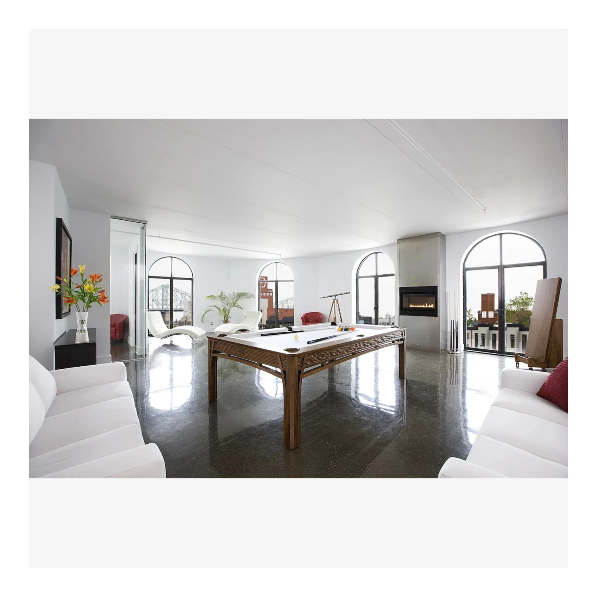 Modern living room with a pool table and white decor