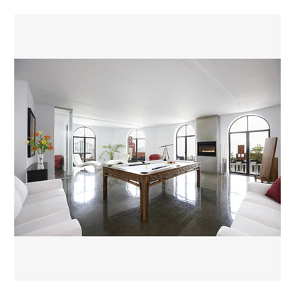 Modern living room with a pool table and white decor