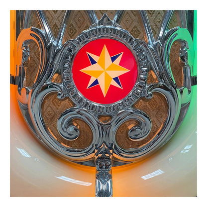 Decorative emblem with a star design on a metallic background