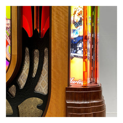 Close-up of a colorful arcade machine with detailed woodwork and vibrant graphics.