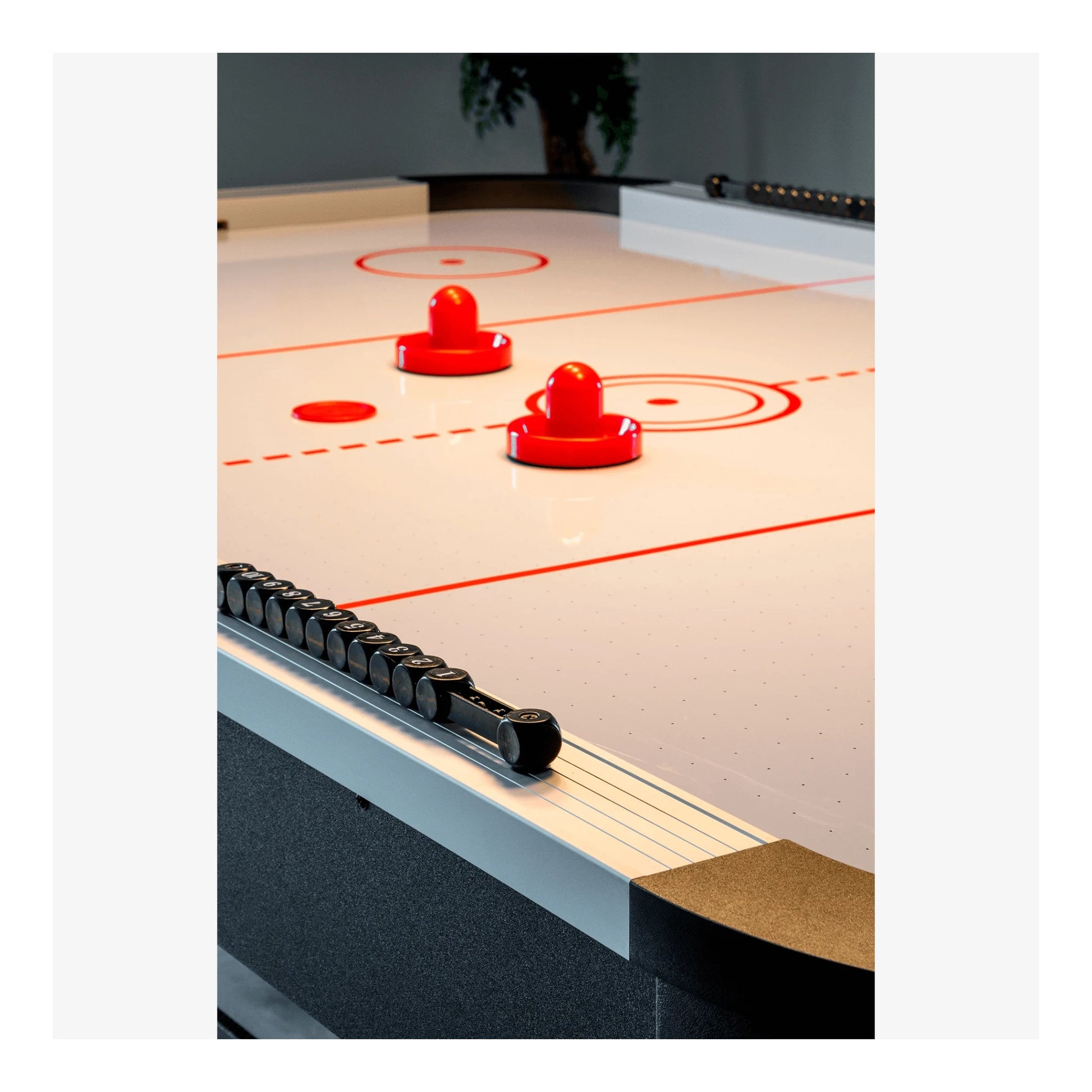 A close-up detail shot of the Master Speed air hockey table's corner and side rail, showing the quality construction and modern logo.