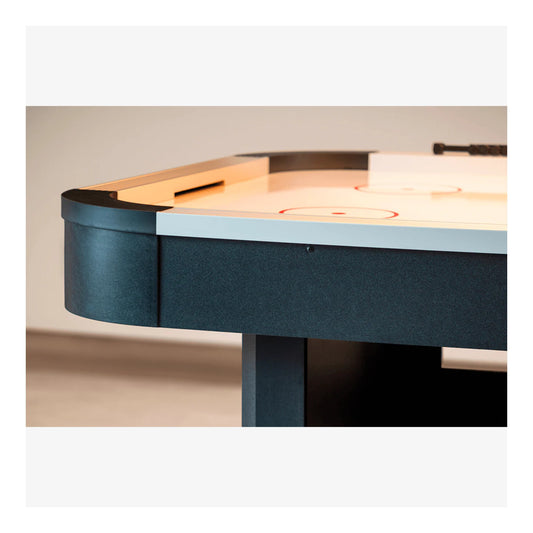 A full-length view of the Master Speed 7-foot air hockey table, showing its white playing surface, black rails, and sturdy black pedestal base.