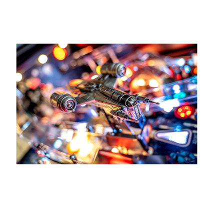 Close-up of a pinball machine with colorful lights and a detailed playfield.