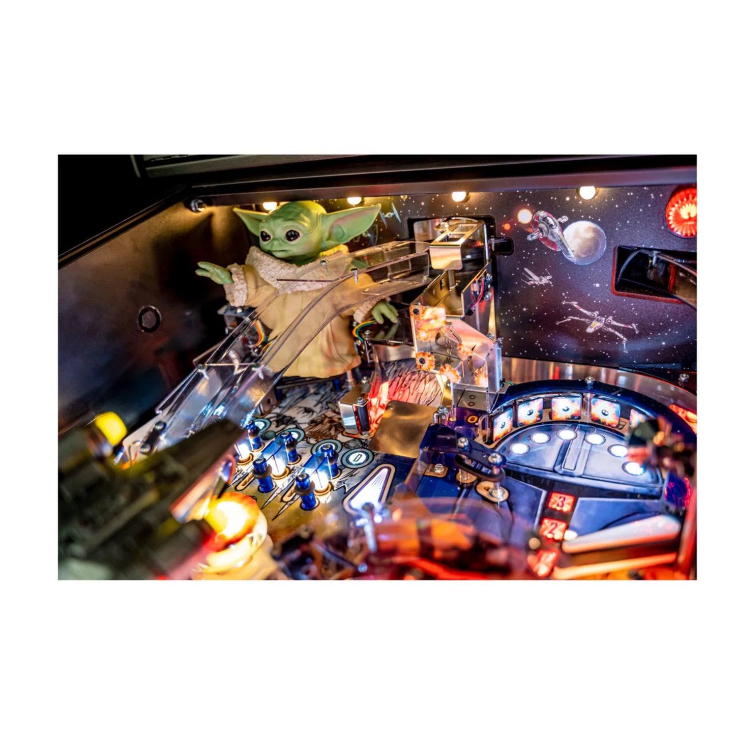 Pinball machine with a character resembling The Child from 'The Mandalorian' on a white background