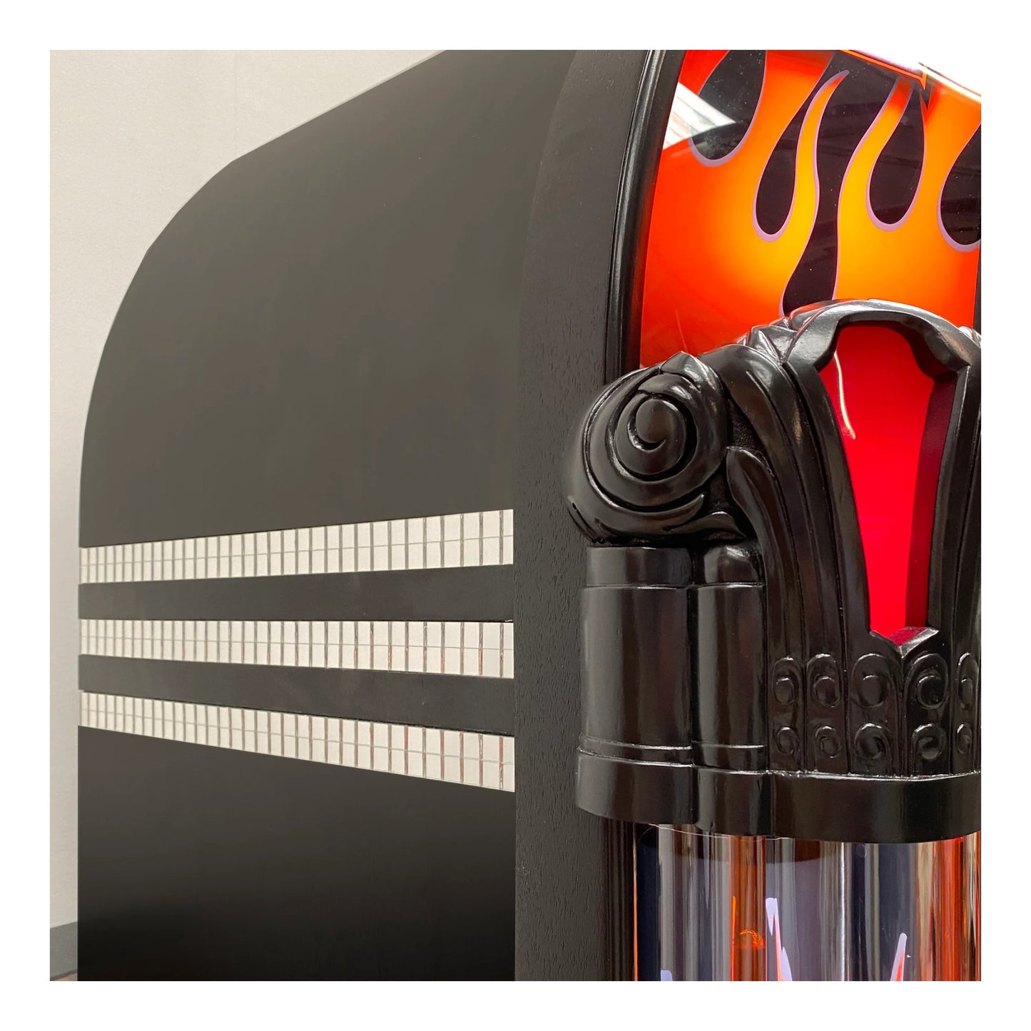 Close-up of a motorcycle handlebar with flame design and brand logo.