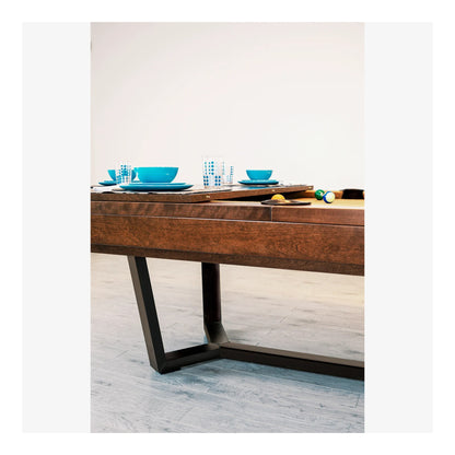 Wooden dining table with blue dishes on a light gray floor.