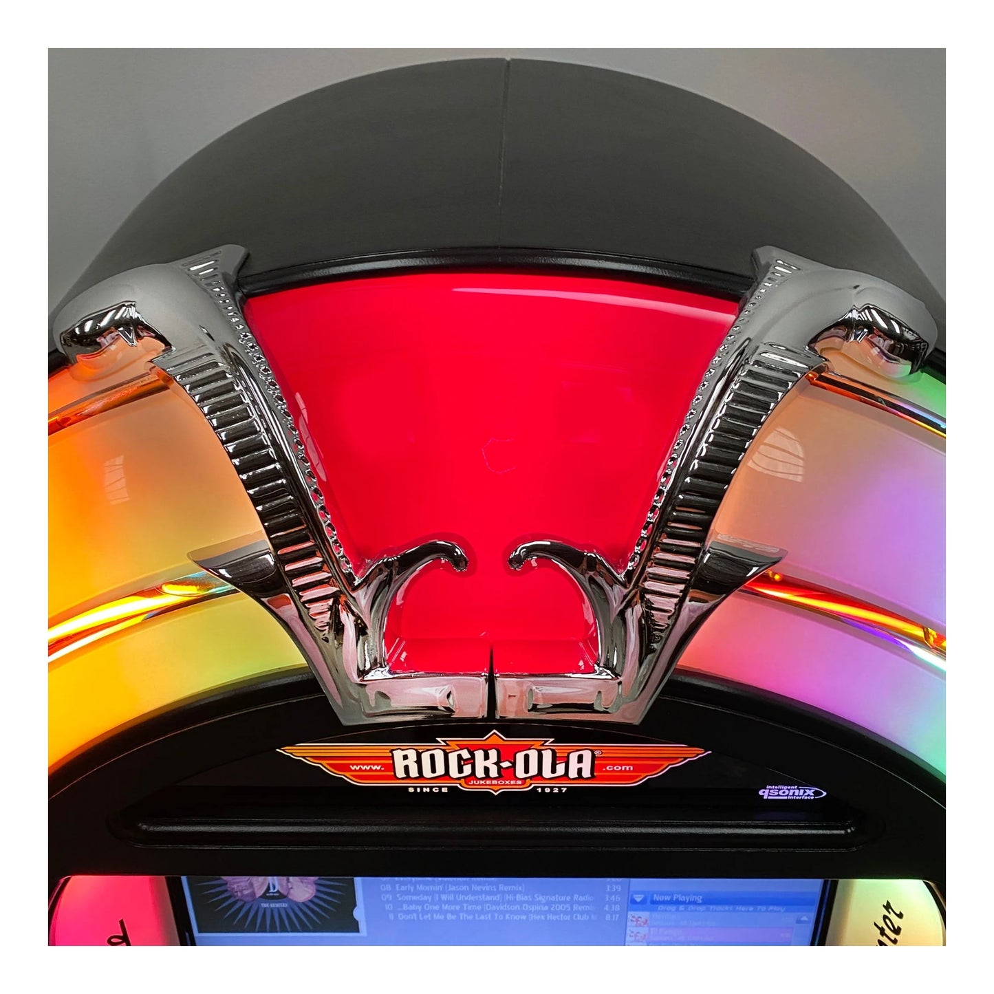 Close-up of a Rock-Ola jukebox with colorful interior lights.