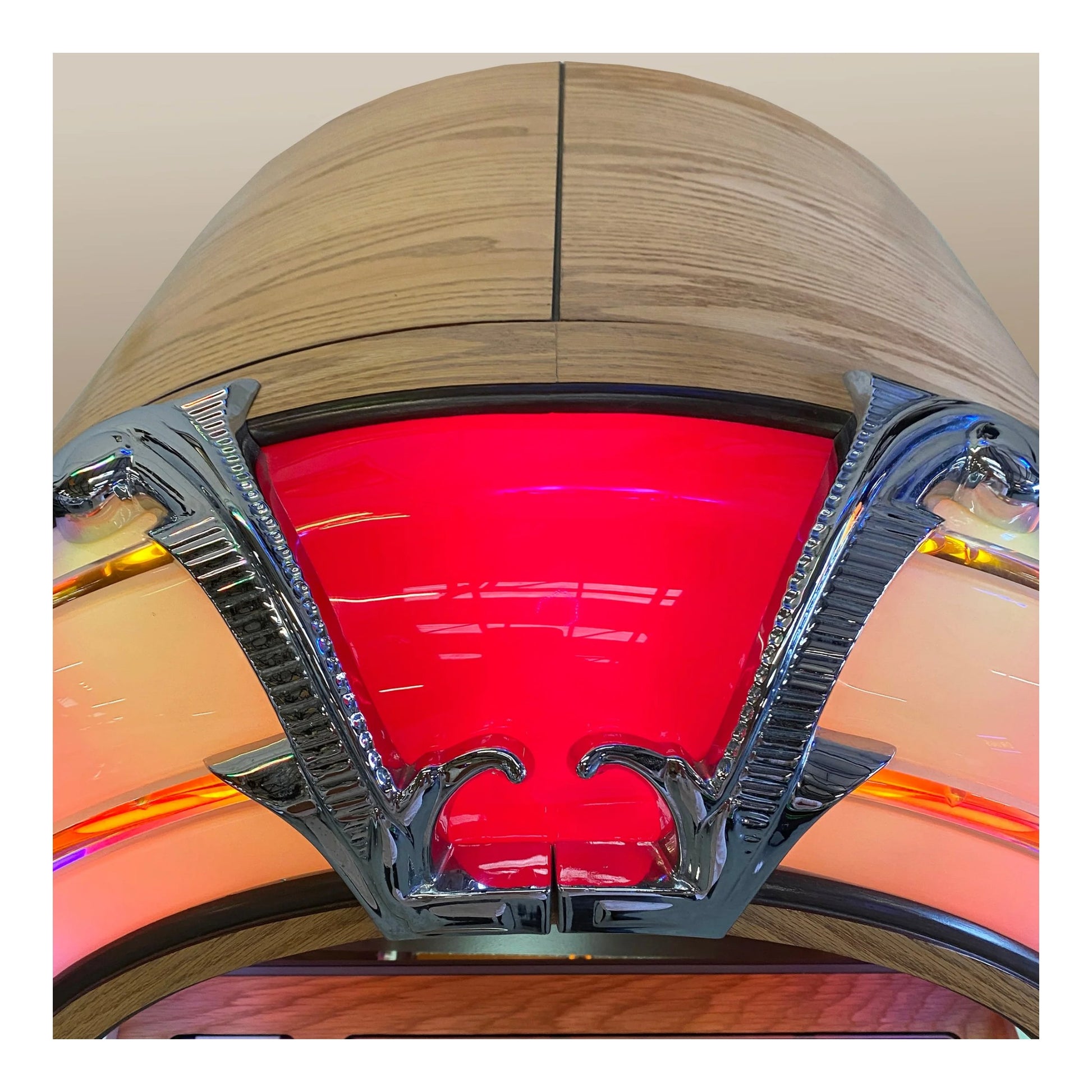Decorative ceiling light fixture with red glass shade and metallic frame.