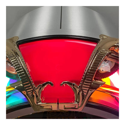 Close-up of a colorful light fixture with red glass and gold metalwork.