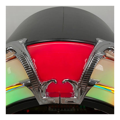 Close-up of a red light with chrome frame on a motorcycle helmet.