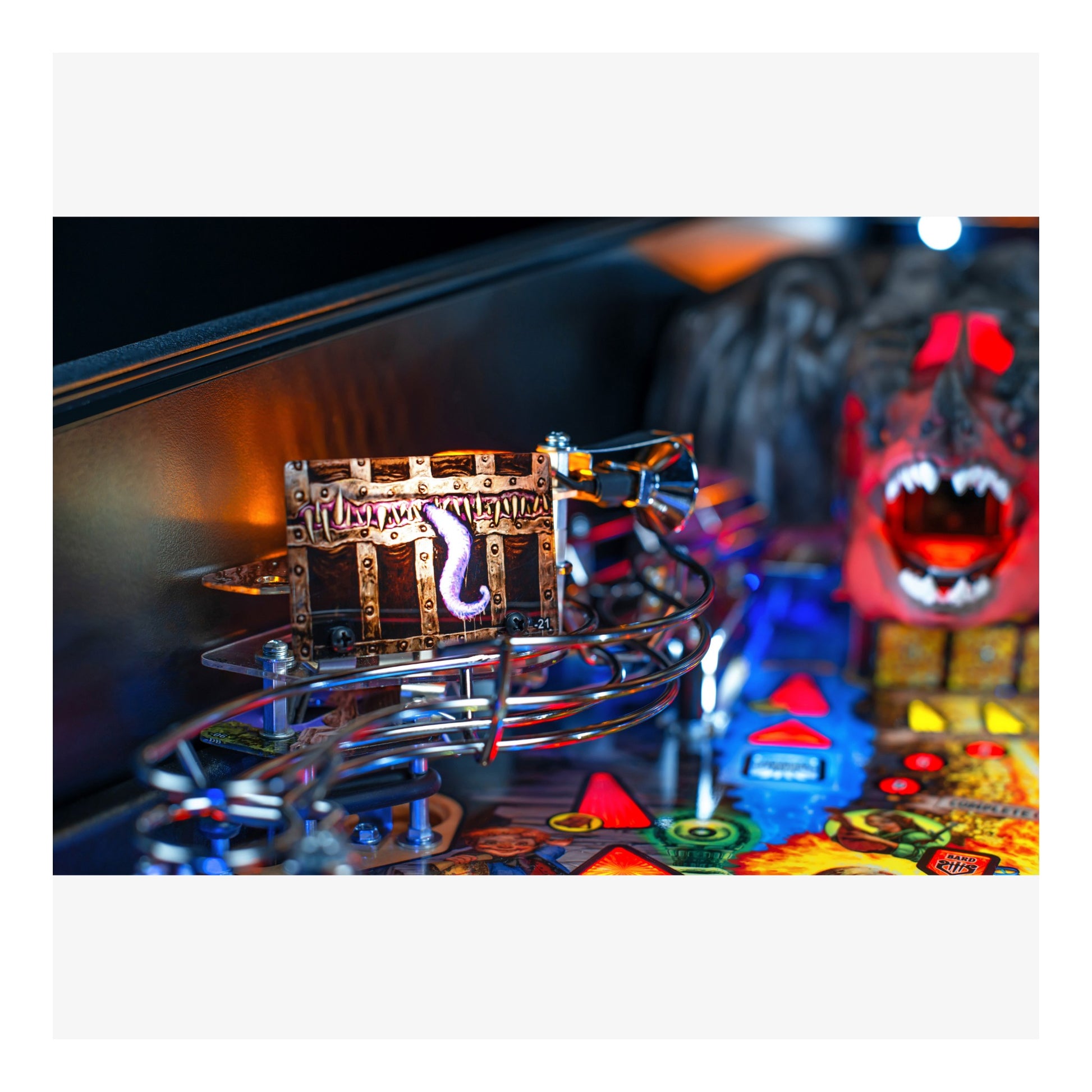 Close-up of a pinball machine with a colorful playfield and a detailed cabinet.