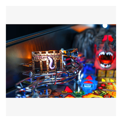 Close-up of a pinball machine with a colorful playfield and a detailed cabinet.
