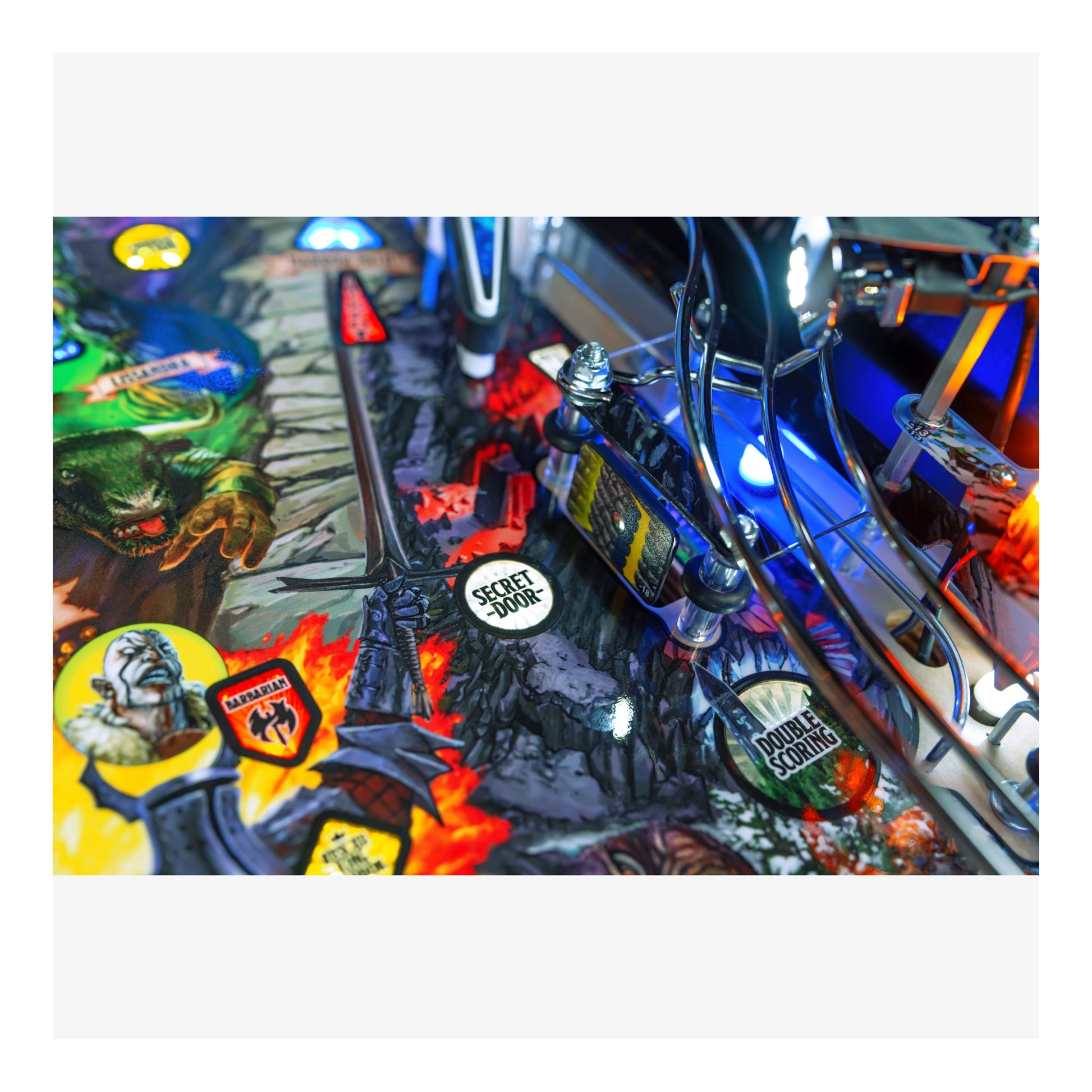 Close-up of a colorful pinball machine with various characters and symbols.