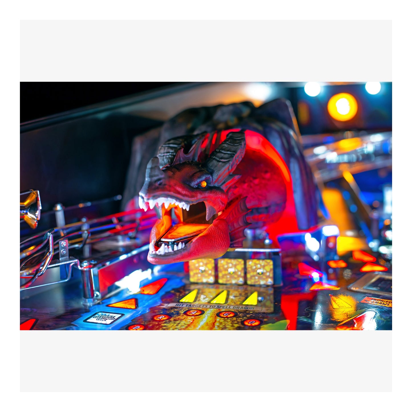 Close-up of a pinball machine with a dragon head design.