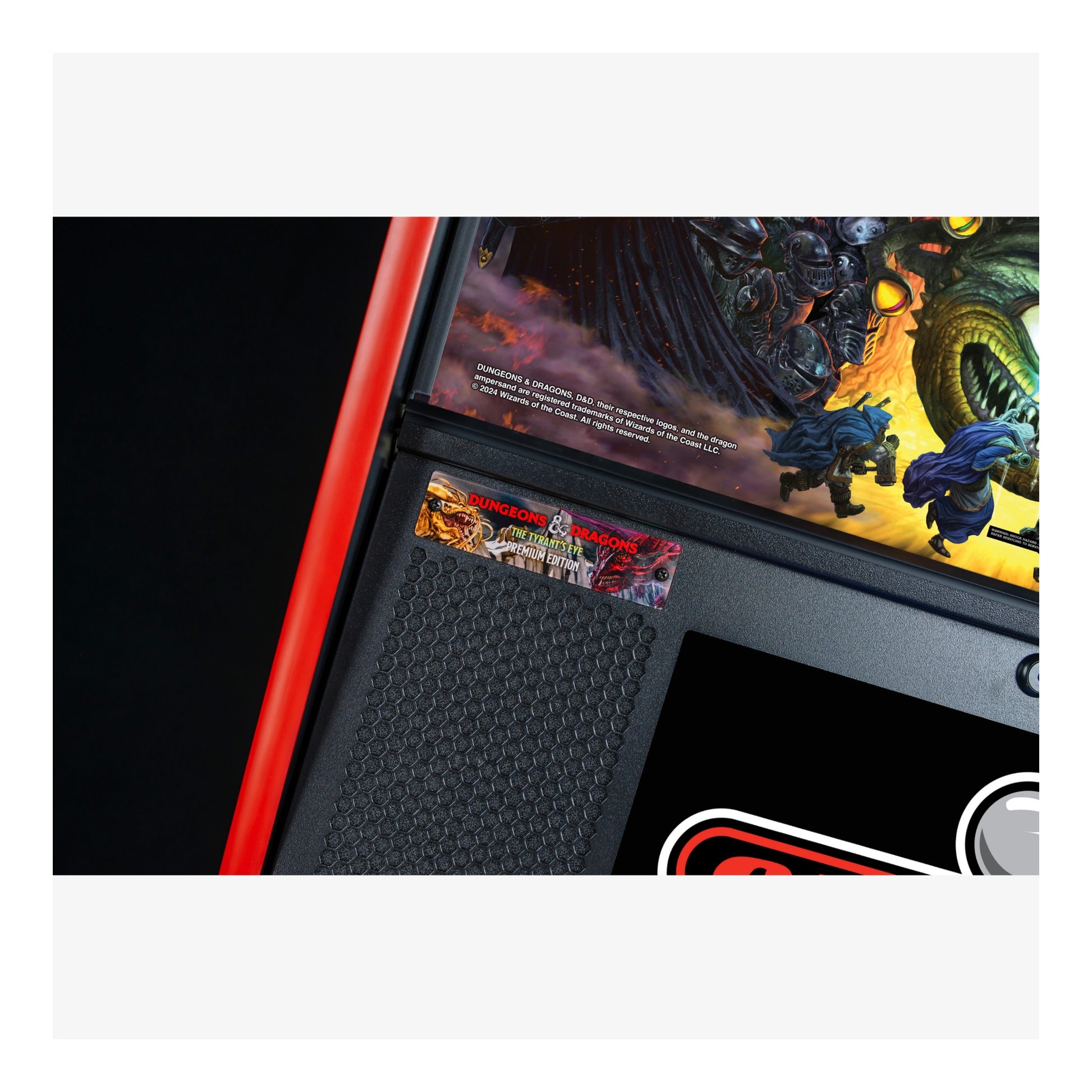 Close-up of a pinball machine with detailed artwork and red border.