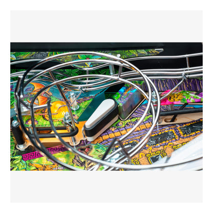 Close-up of a pinball machine with colorful artwork and a large metal hoop.