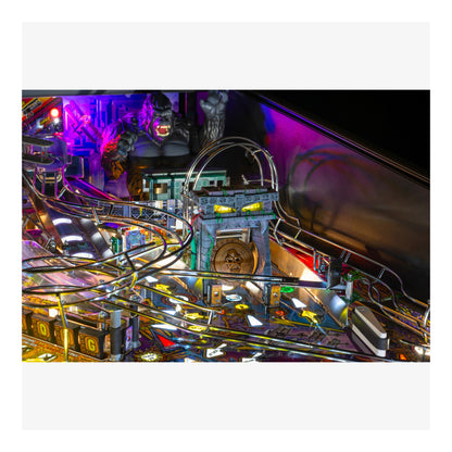 Close-up of a pinball machine with colorful lights and reflective surface.