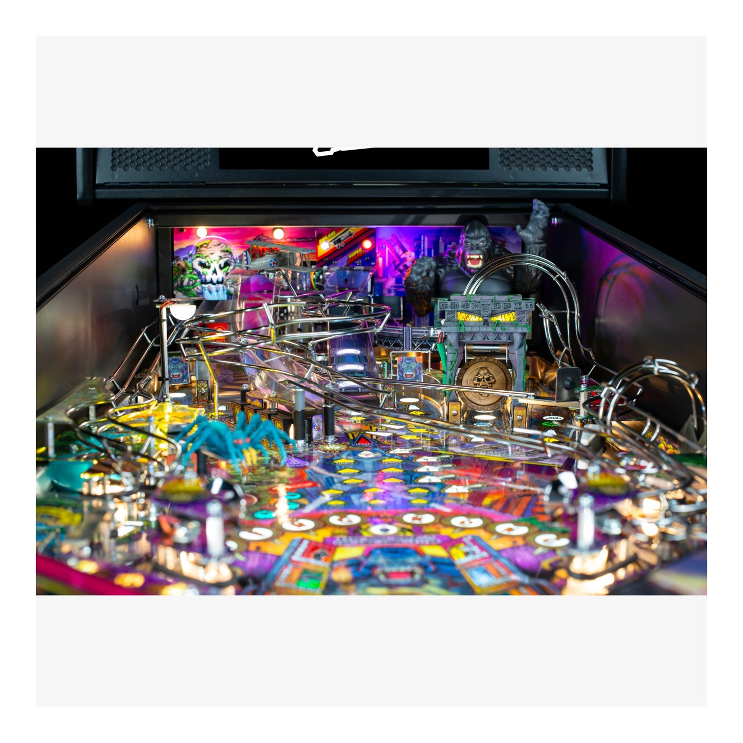 Pinball machine with colorful design and various components on a black background