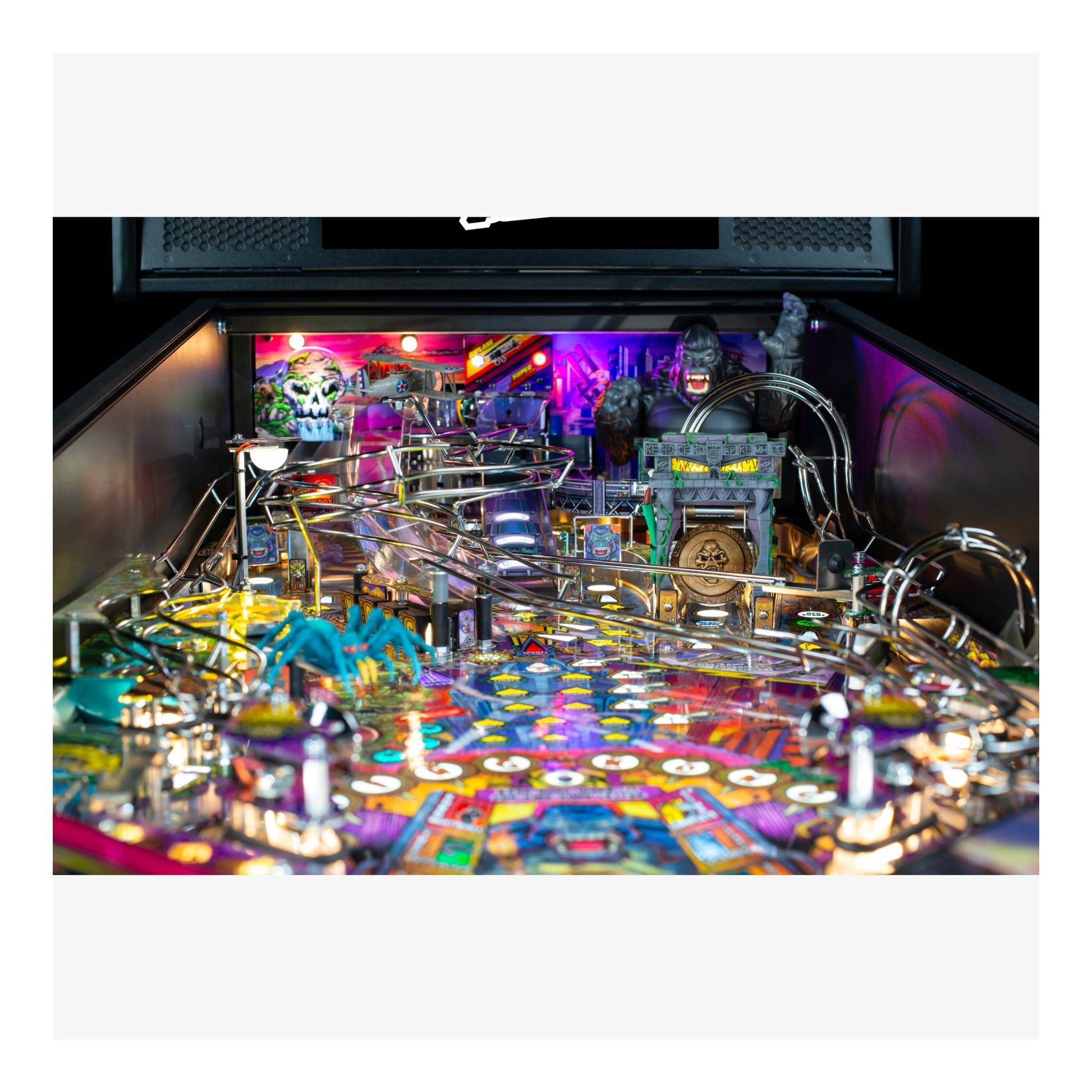 Pinball machine with colorful design and various components on a black background