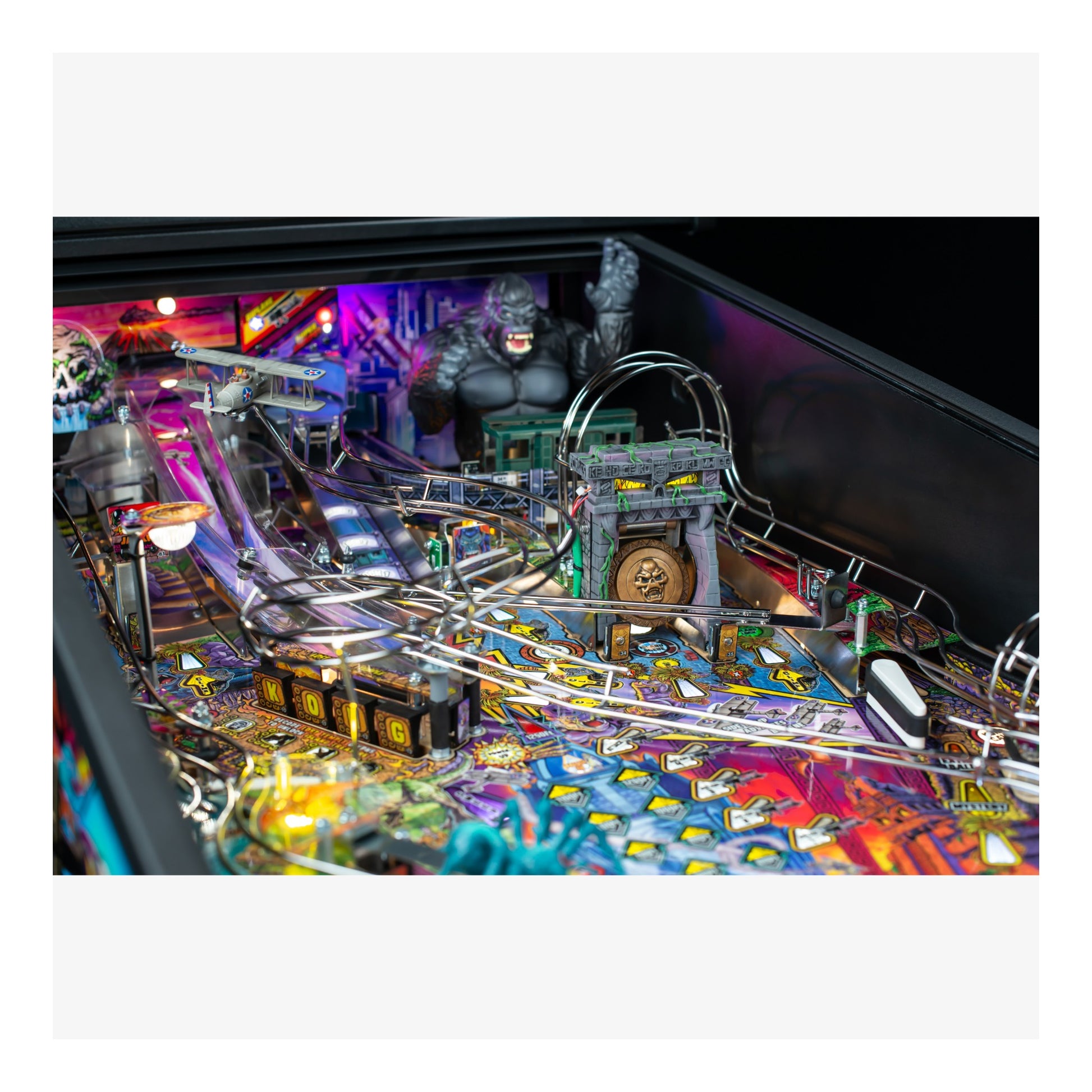 Pinball machine with colorful design and characters on a white background