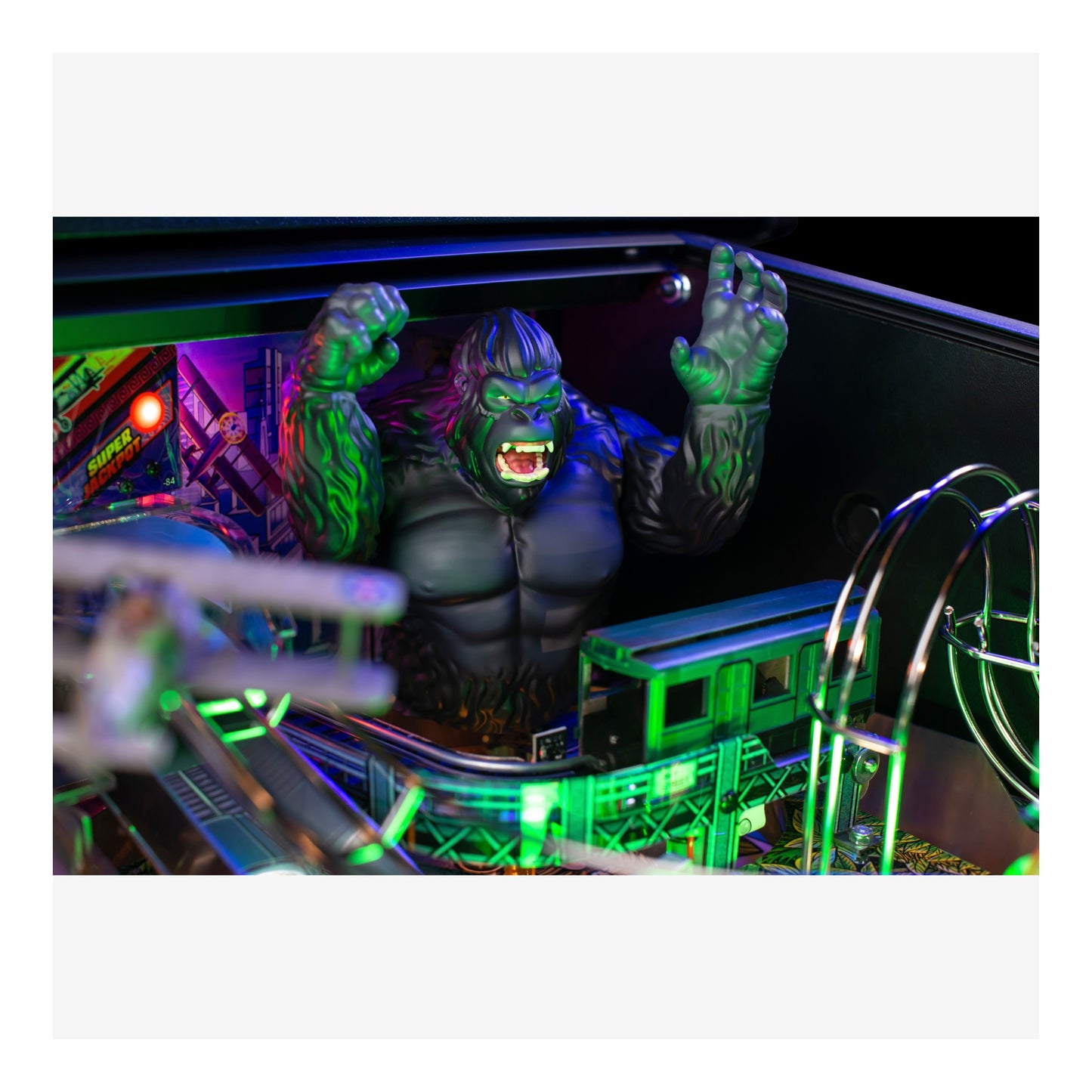 Toy figure of a muscular character with green accents in a dark setting with neon lights.