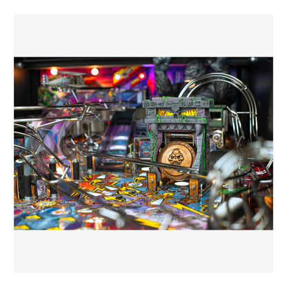 Close-up of a pinball machine with colorful playfield and detailed design.