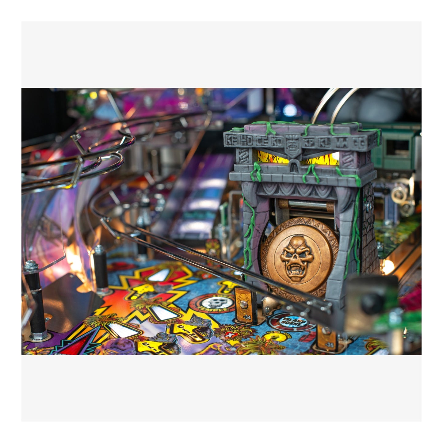 Close-up of a pinball machine with colorful playfield and detailed design.