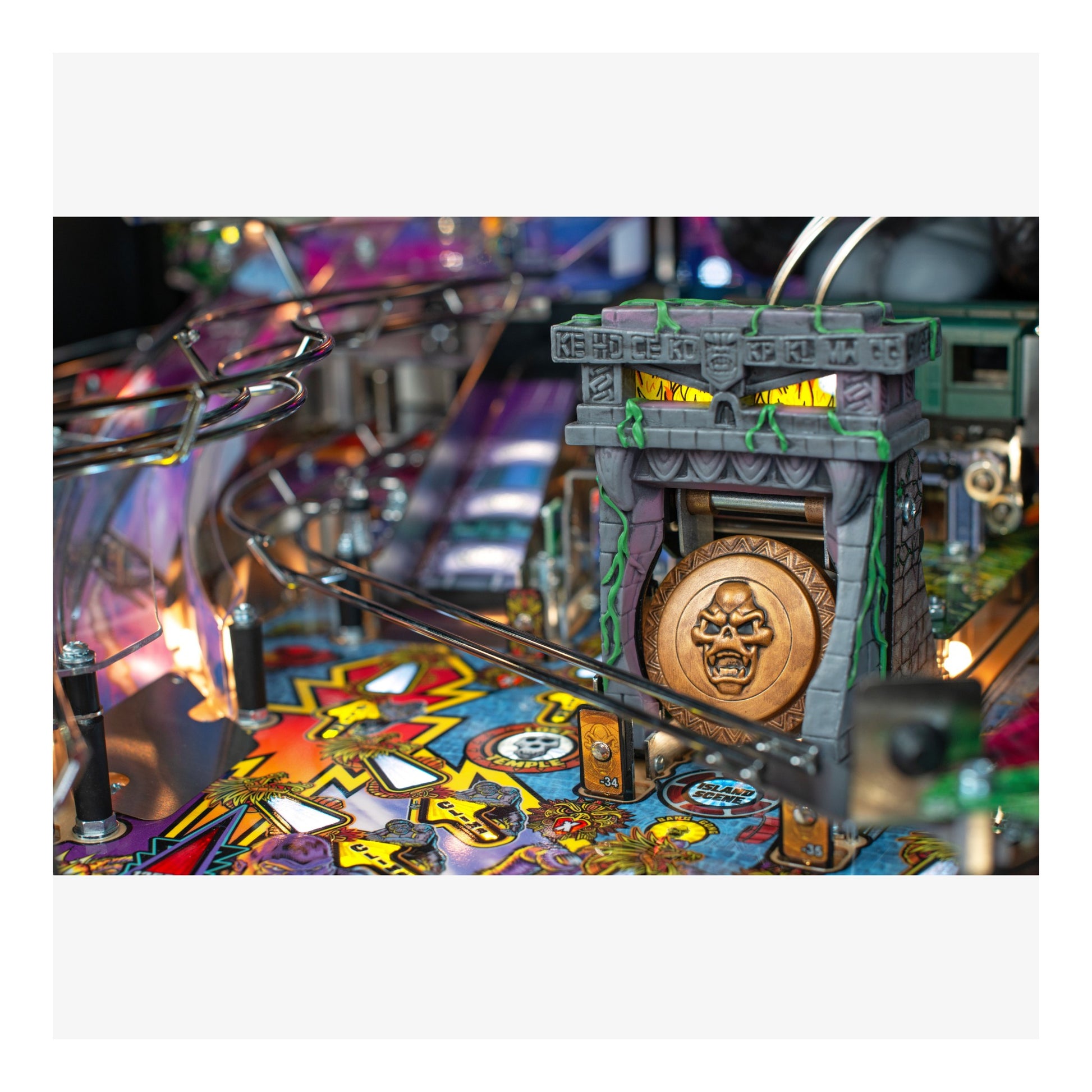 Close-up of a pinball machine with colorful playfield and detailed design.